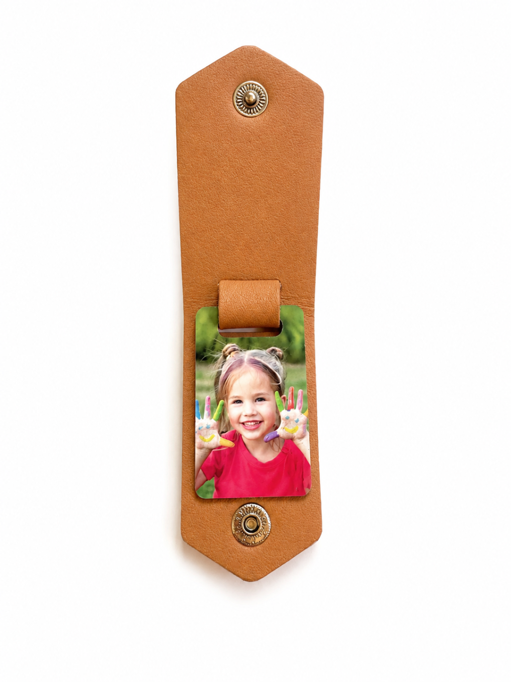 A tan leather keychain or key ring with brass snap buttons and a central photo holder displaying a child's picture, shown on a plain white background.