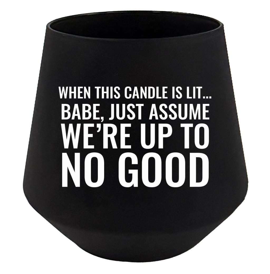Black candle holder with humorous text on a white background