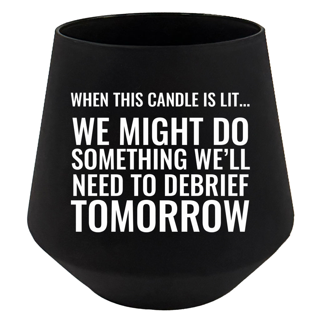 Black candle holder with humorous text on a white background