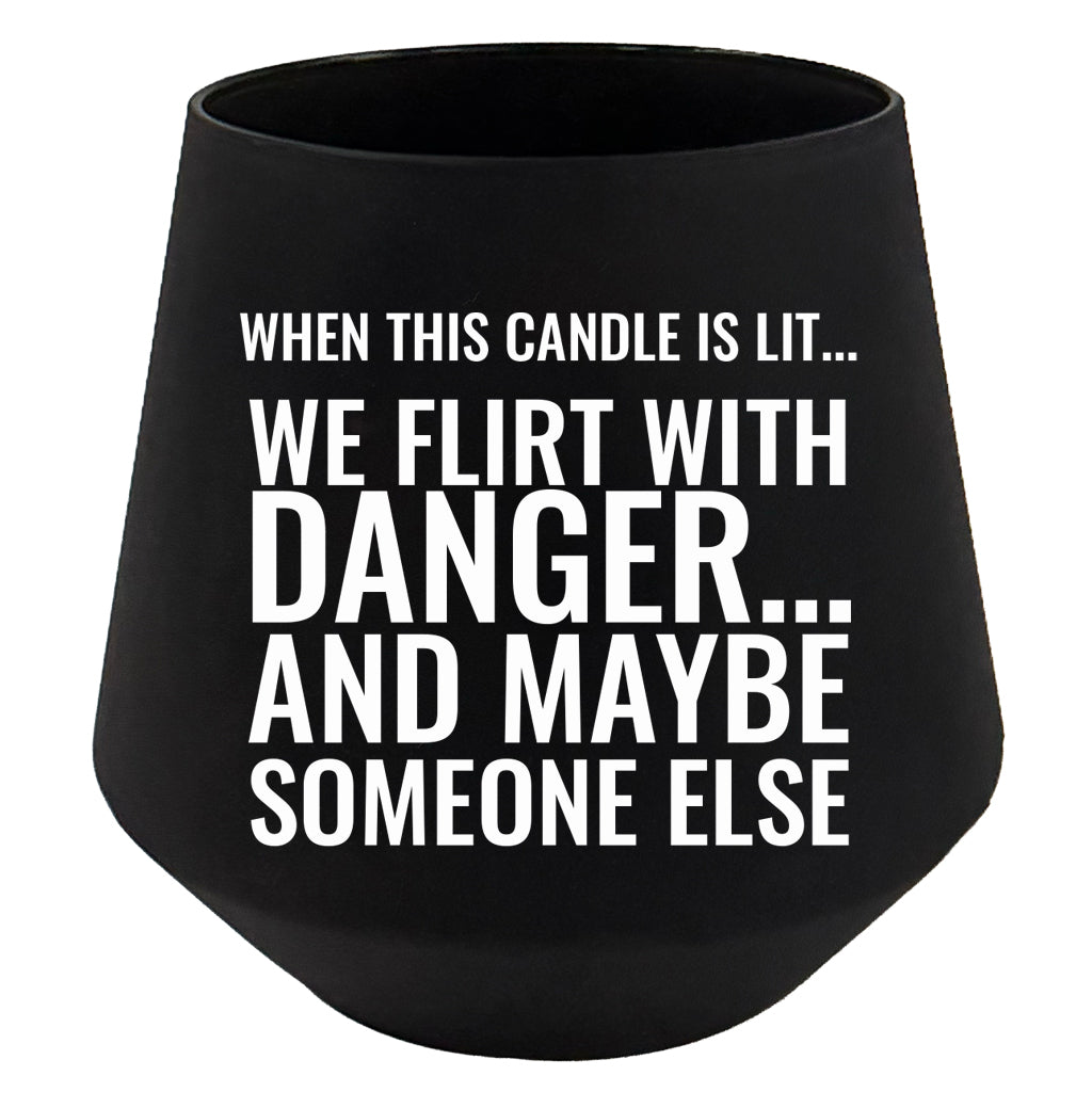 Black candle holder with white text on a white background