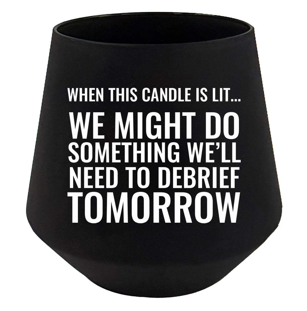 Black candle holder with humorous text on a white background