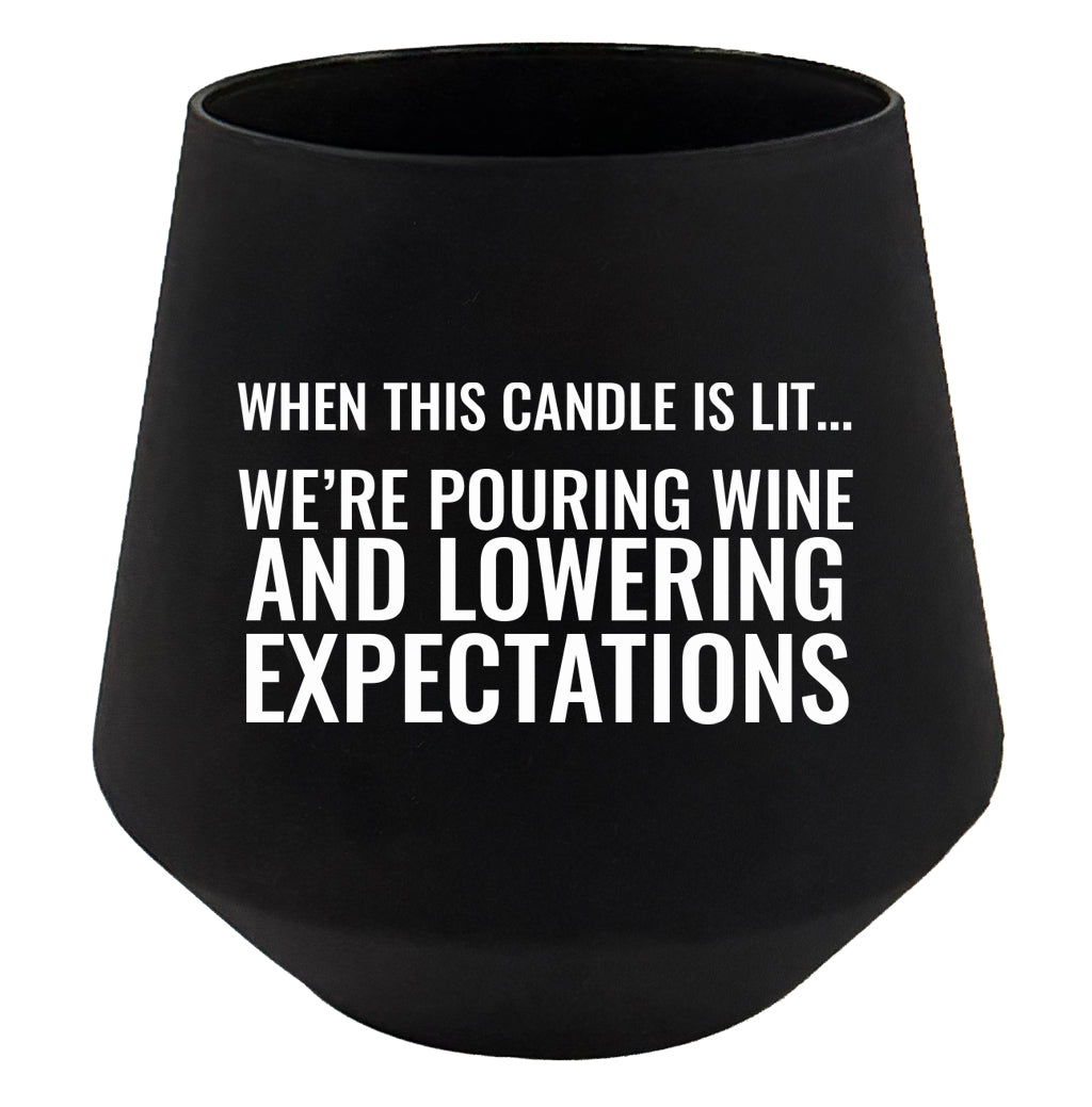 Black candle holder with humorous text on a white background