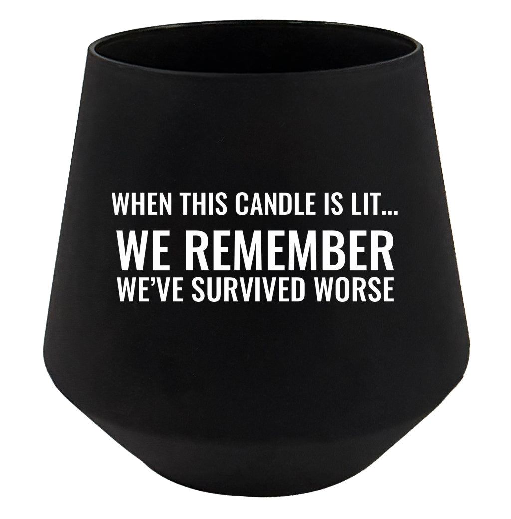 Black candle holder with white text on a white background