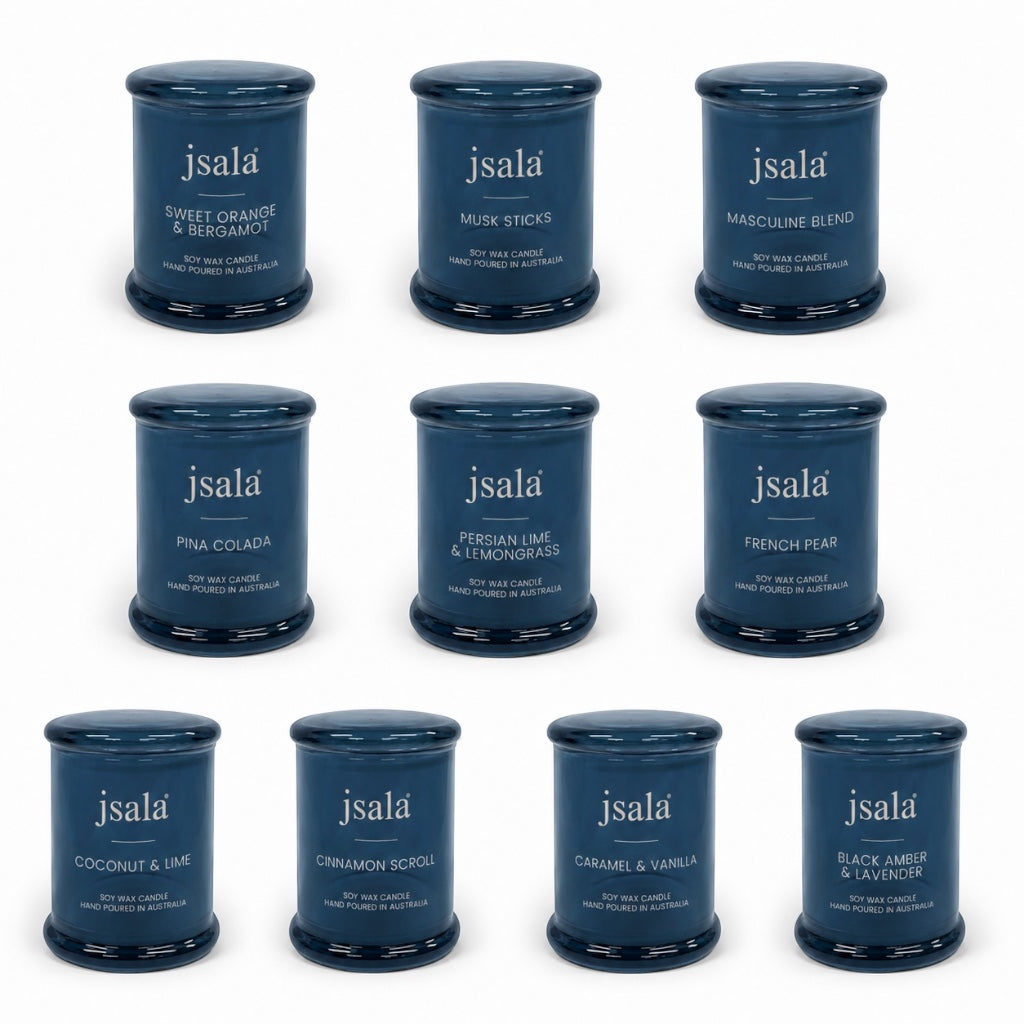 Collection of blue Jsala candles in various scents on a white background