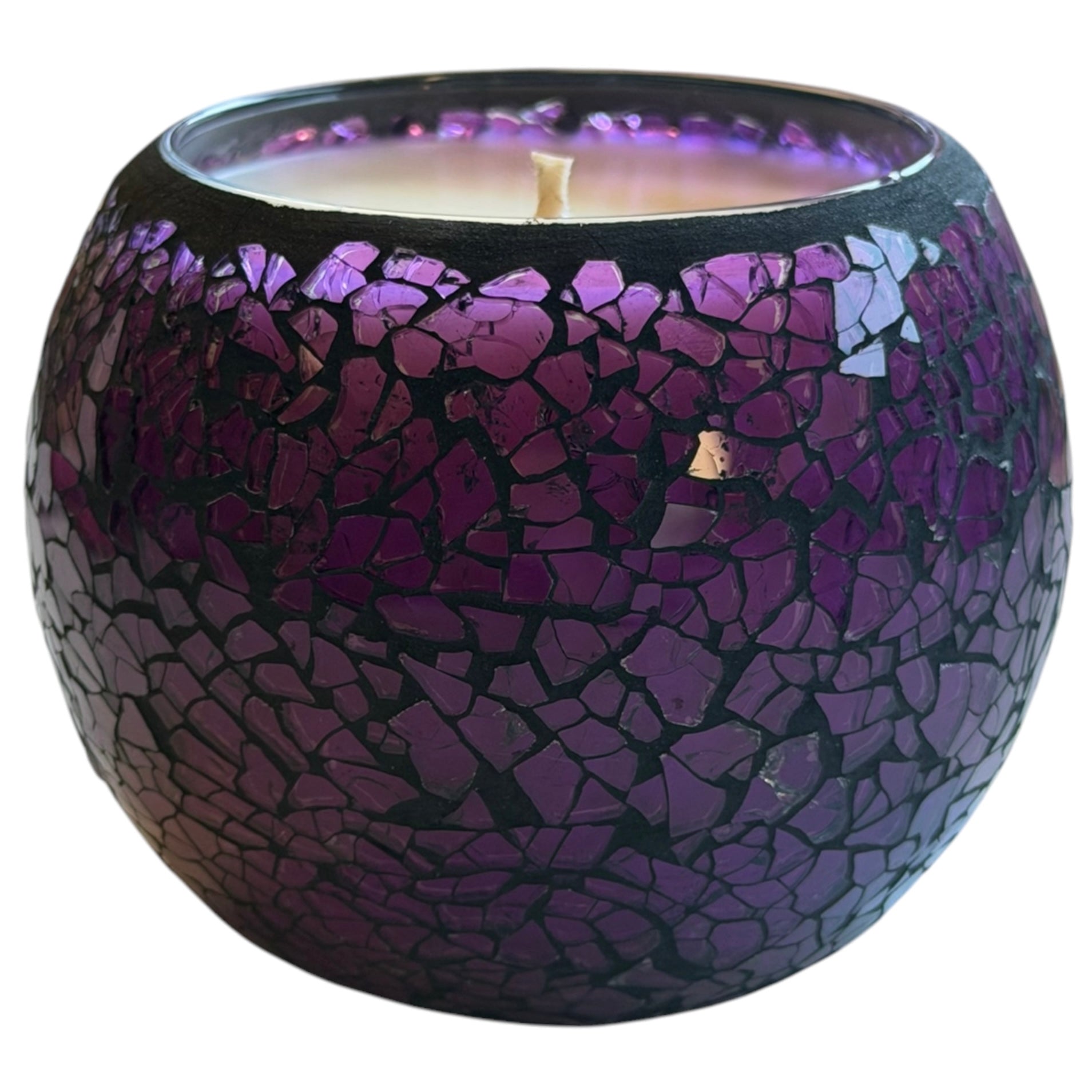 Candle in a dark purple mosaic glass. 