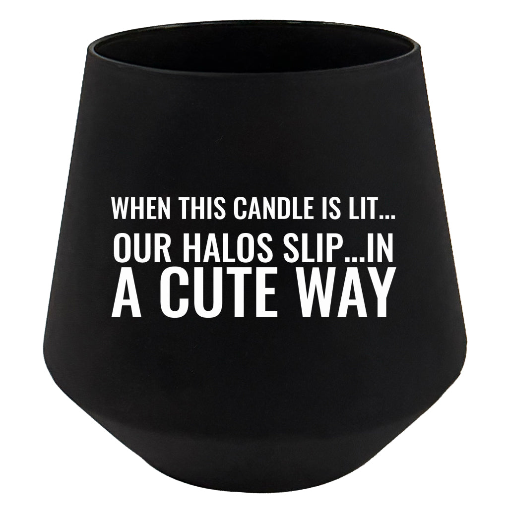 Black candle holder with humorous text on a white background