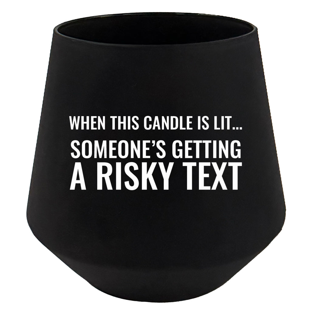 Black candle holder with humorous text on a white background