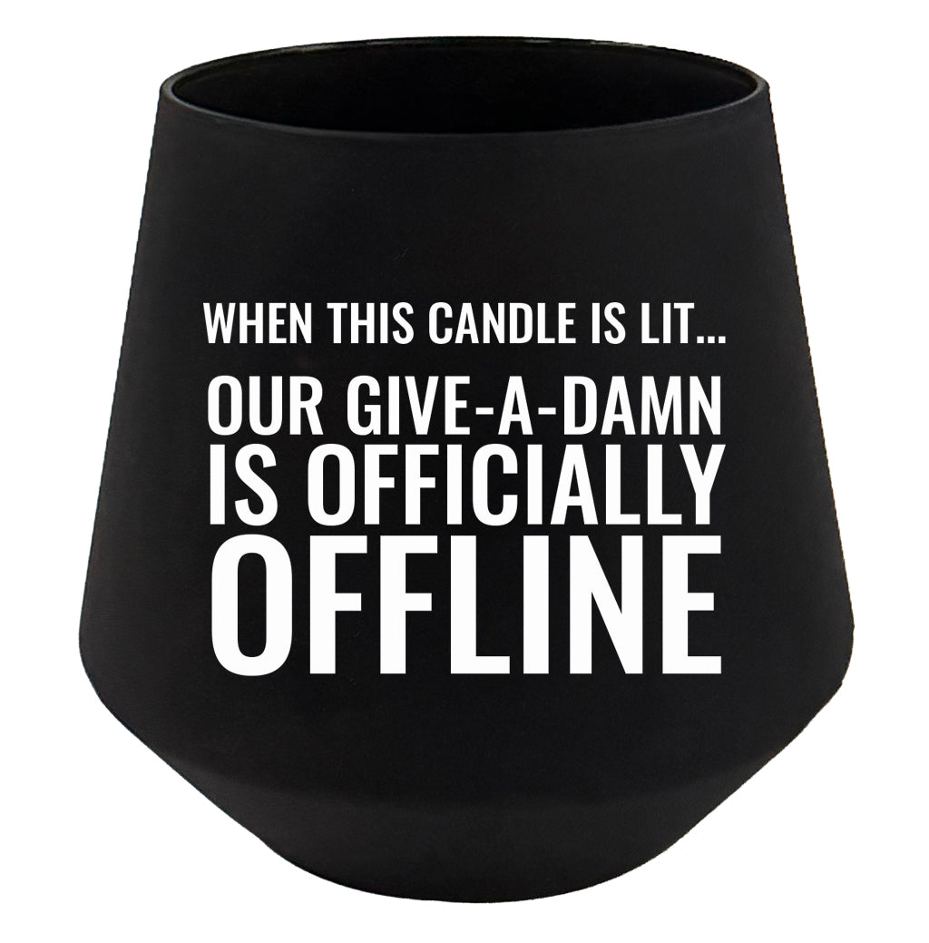 Black candle holder with humorous text on a white background