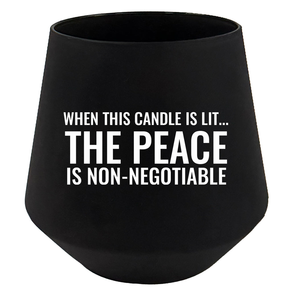 Black candle holder with white text on a white background