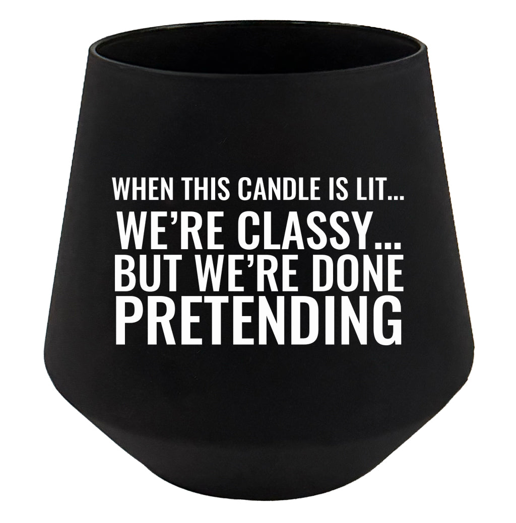 Black candle holder with humorous text on a white background