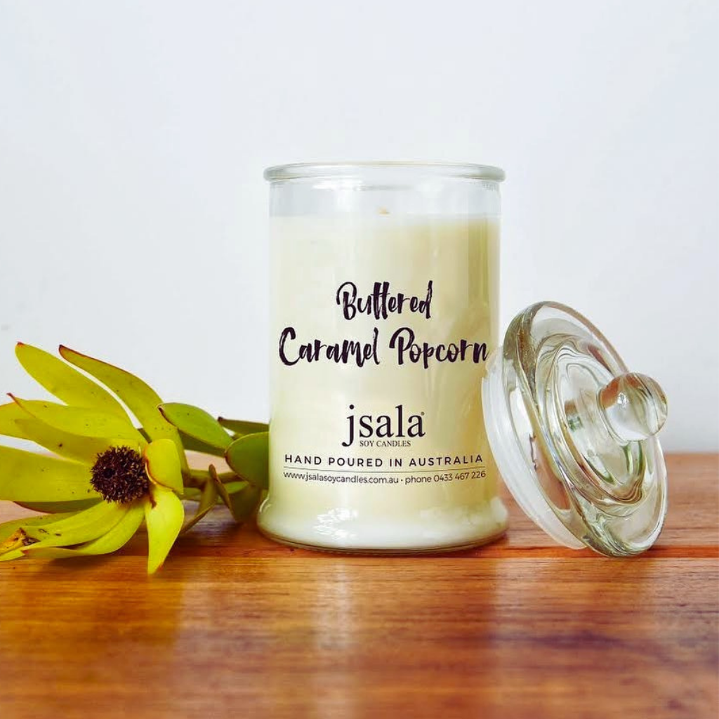 Small glass Apothecary jar filled with Buttered Caramel Popcorn candle by Jsala Soy Candles