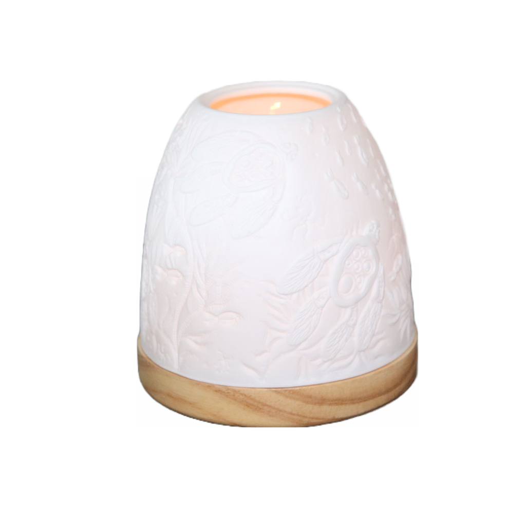 This delicate handmade Turtle Minikin Lantern with artwork by Melanie Hava is moulded with fine white porcelain, which sits on a round wooden base. When lit with our tea light candles the warmth of the flame glows through the porcelain and it's true beauty comes to life.