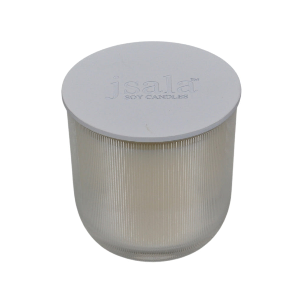 Clear ribbed candle glassware with white lid.